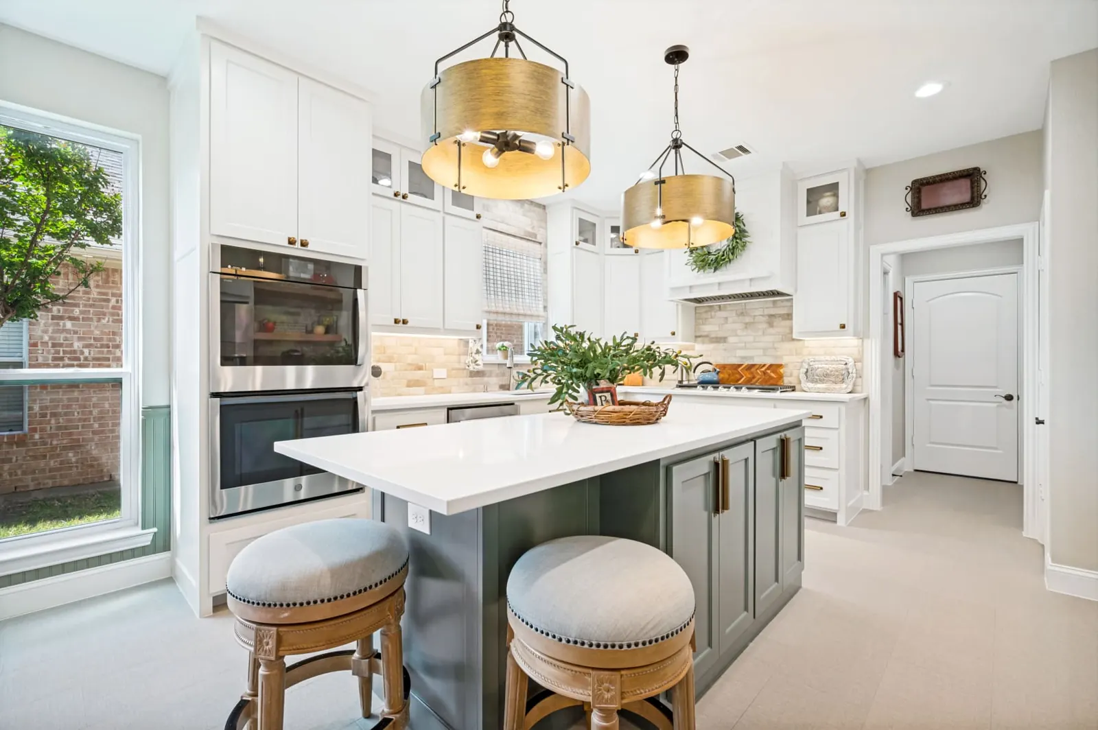 Bright white kitchen remodel with green island