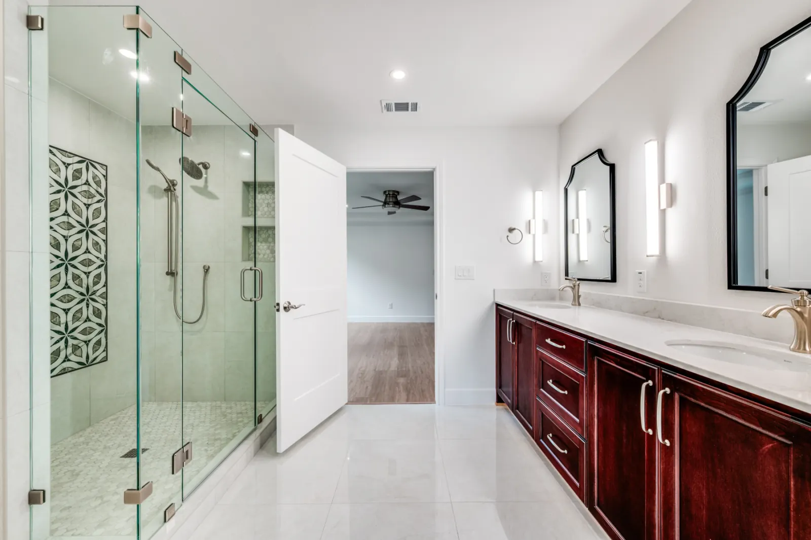 Burgundy vanity with glass shower and patterned tile accent