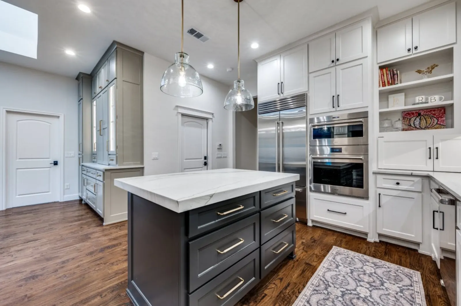 Glass-front cabinets with charcoal marble-topped island